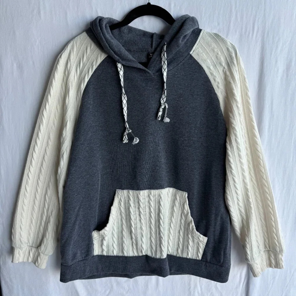 Cozy Two-Tone Knit Hoodie With Cable-Knit Sleeves And Pocket Detail